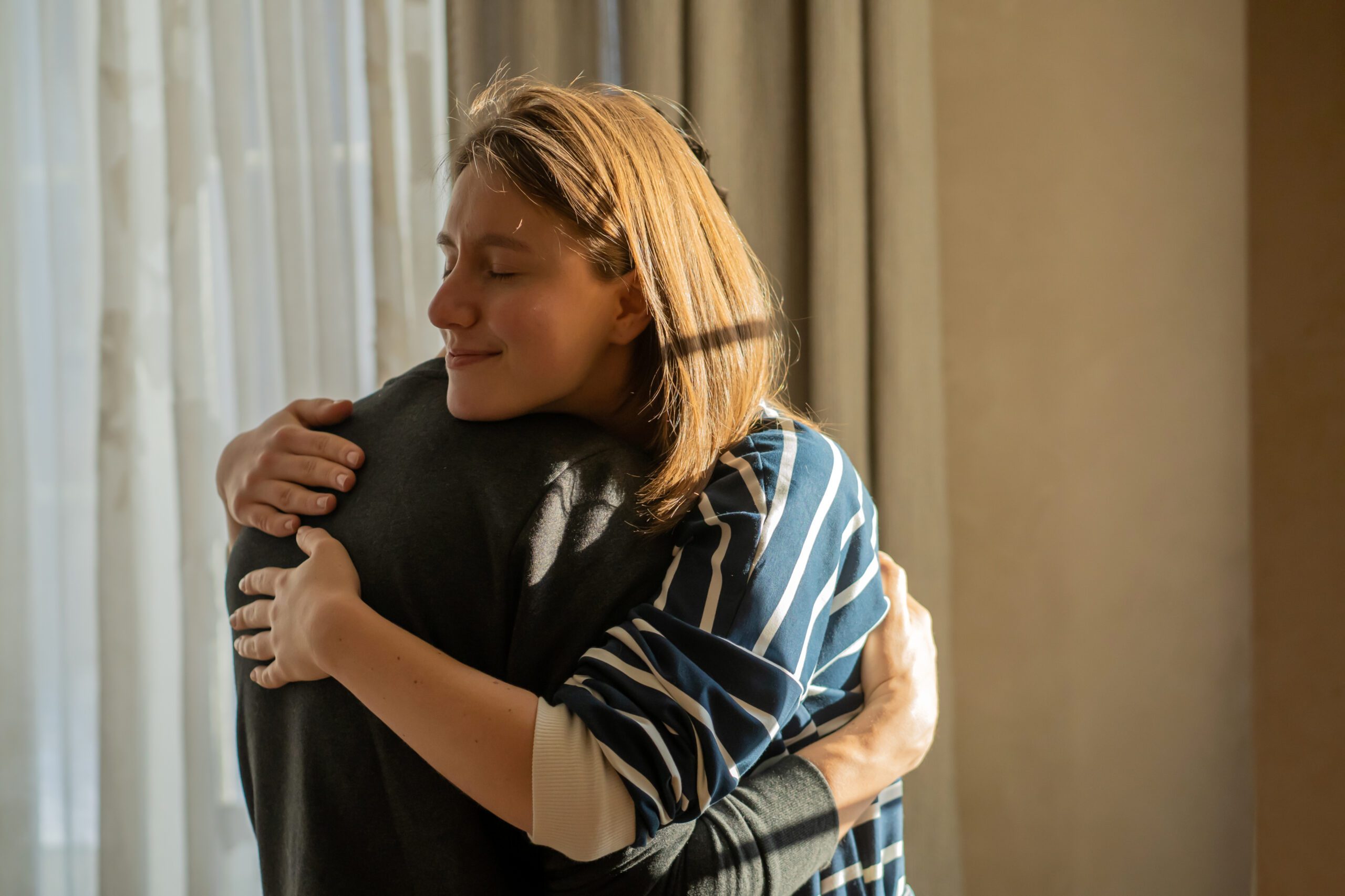 Girl warm hugs a man