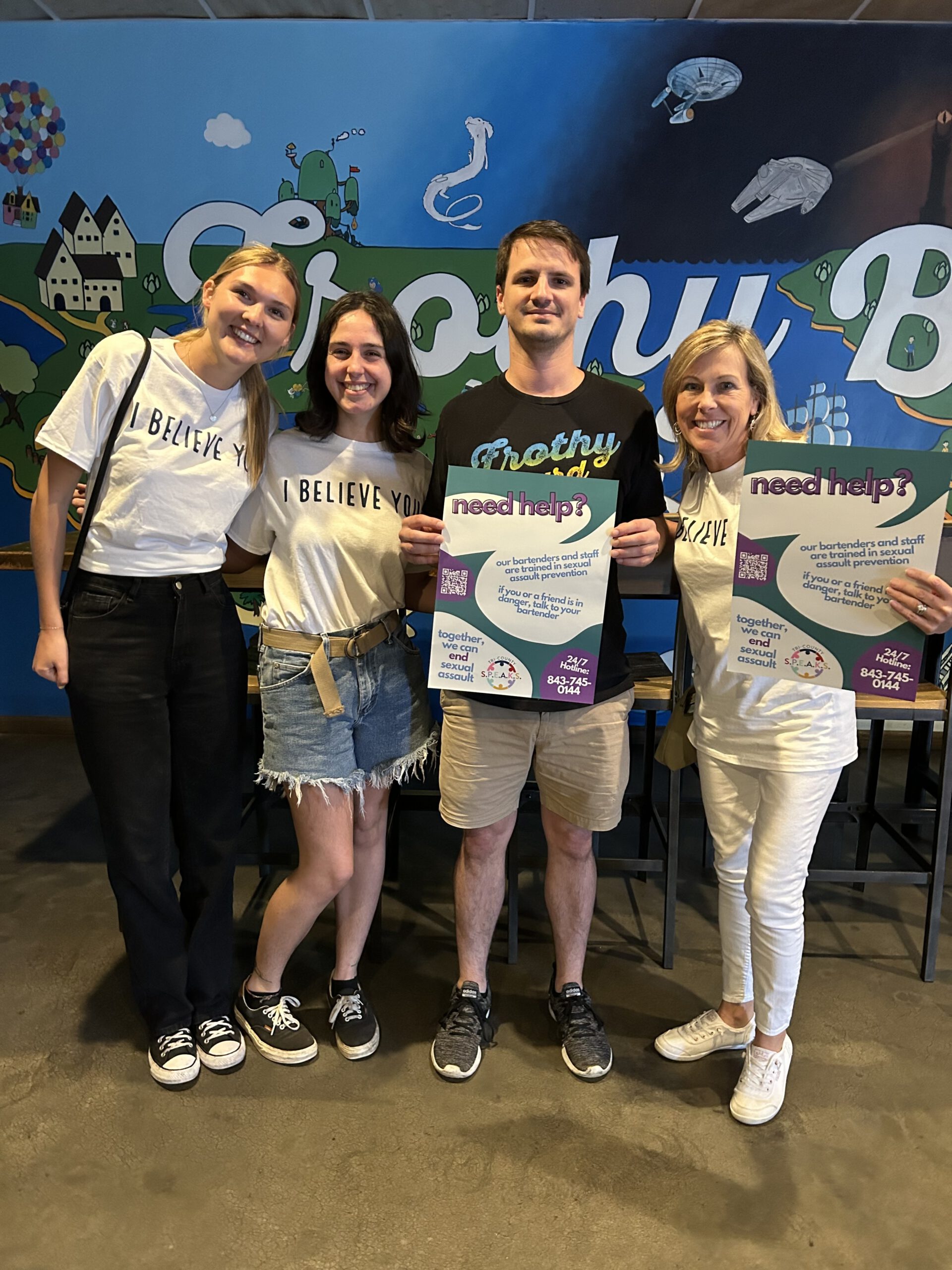 Team of volunteers holding posters